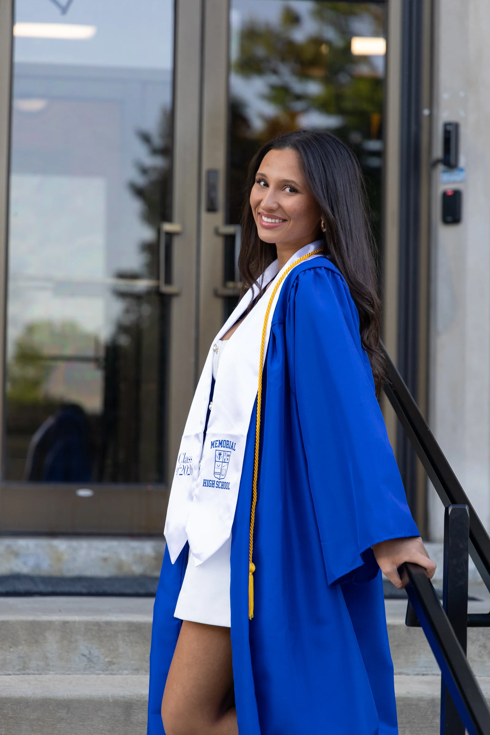 Elizabet looking back on the steps in her graduation gown