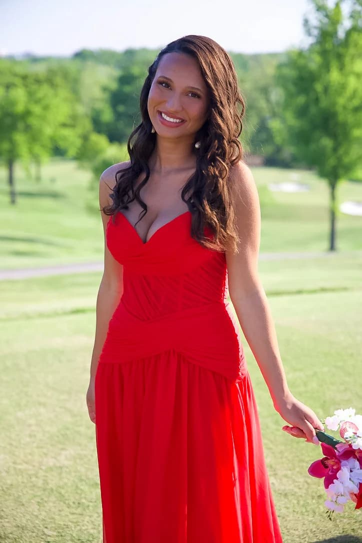 Prom portrait in a red dress by the lake