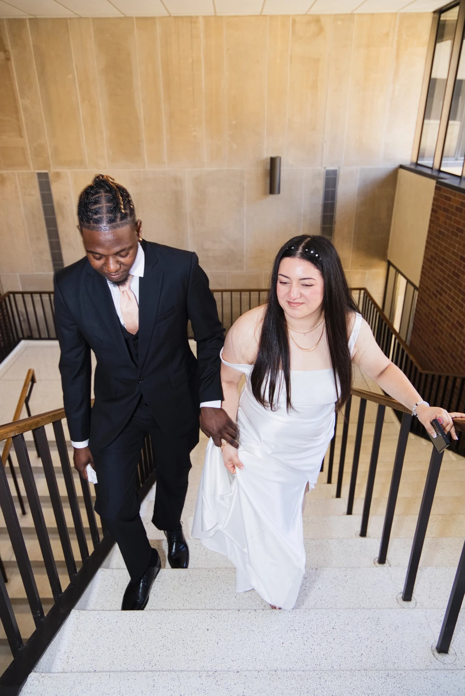 Newlyweds walking up a staircase together